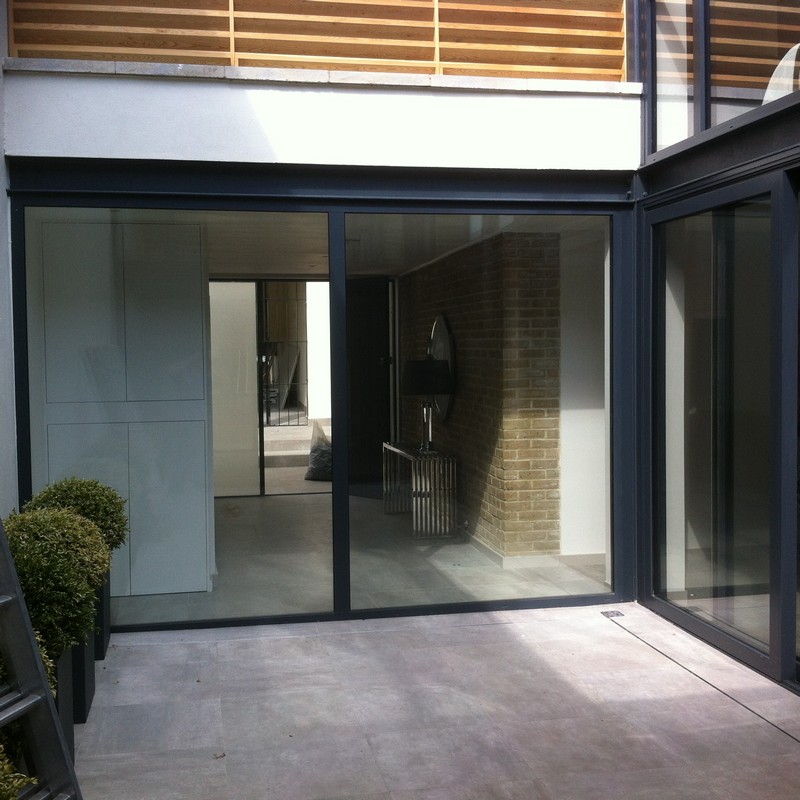 Floor-to-ceiling sliding doors opening to courtyard in Berkhamsted