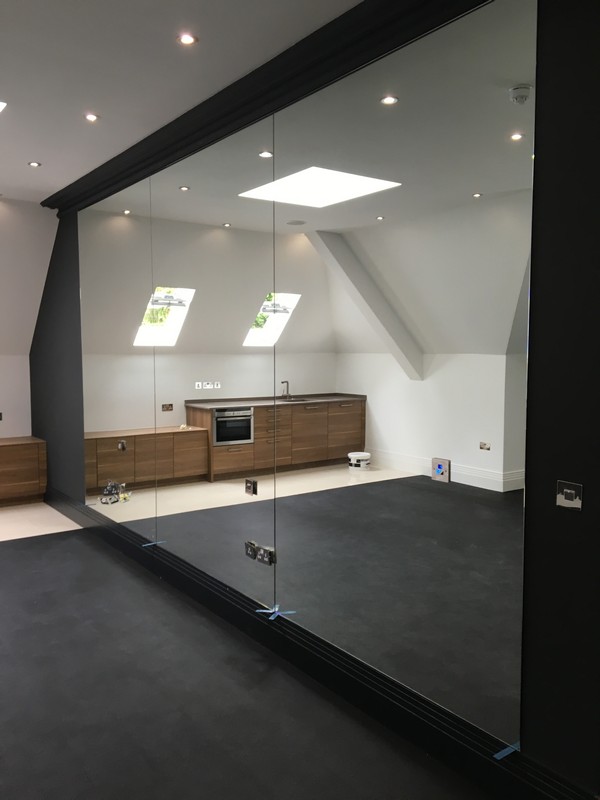 Frameless glass partition in loft conversion by Berkhamsted glaziers