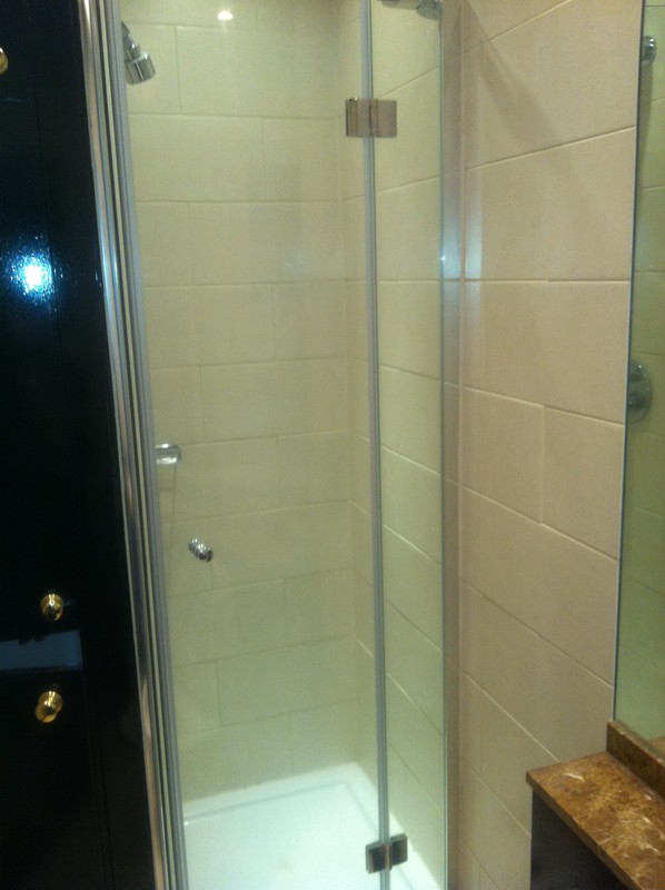 Frameless glass shower enclosure with chrome fittings in Berkhamsted